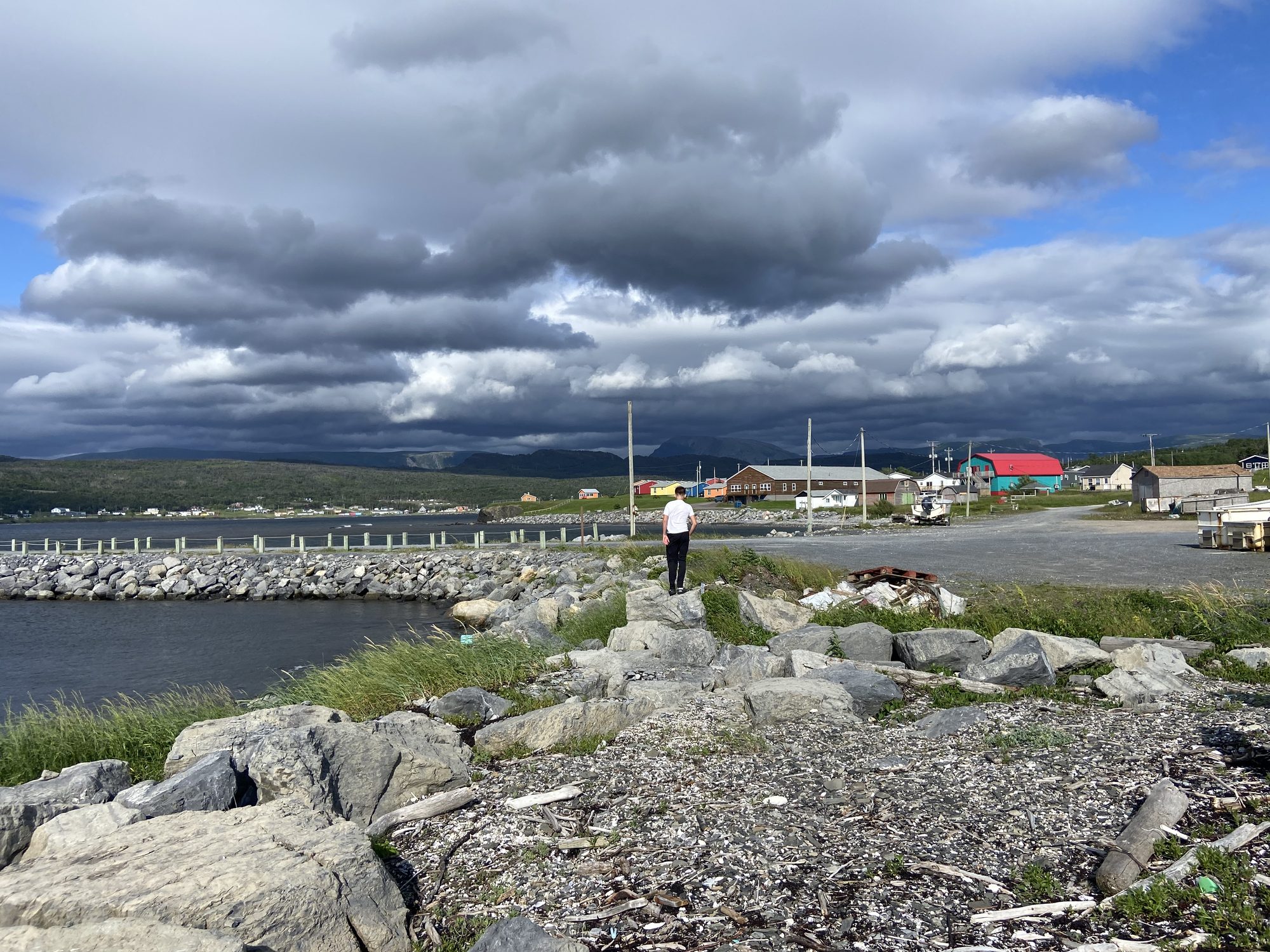 Rocky Harbour waterfront beneath dramatic clouds